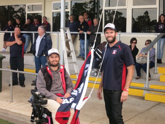 Casey Tutungi & James Garvey unfurl the 2013 GFL Premiership Flag